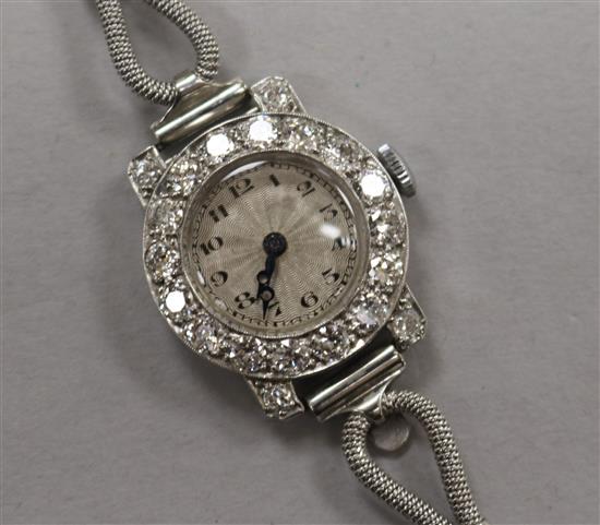 A ladys diamond-set platinum cocktail watch on 18ct white gold bracelet.